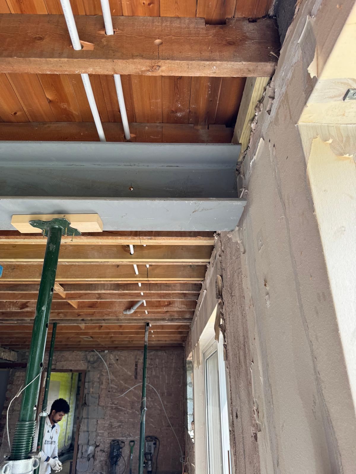 Steel beam bearing on structural support within an existing masonry wall