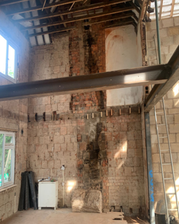 Structural steel frame supporting a large residential opening