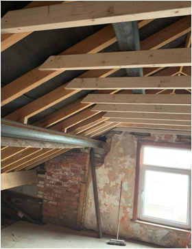 Existing roof structure exposed at the start of a loft conversion project