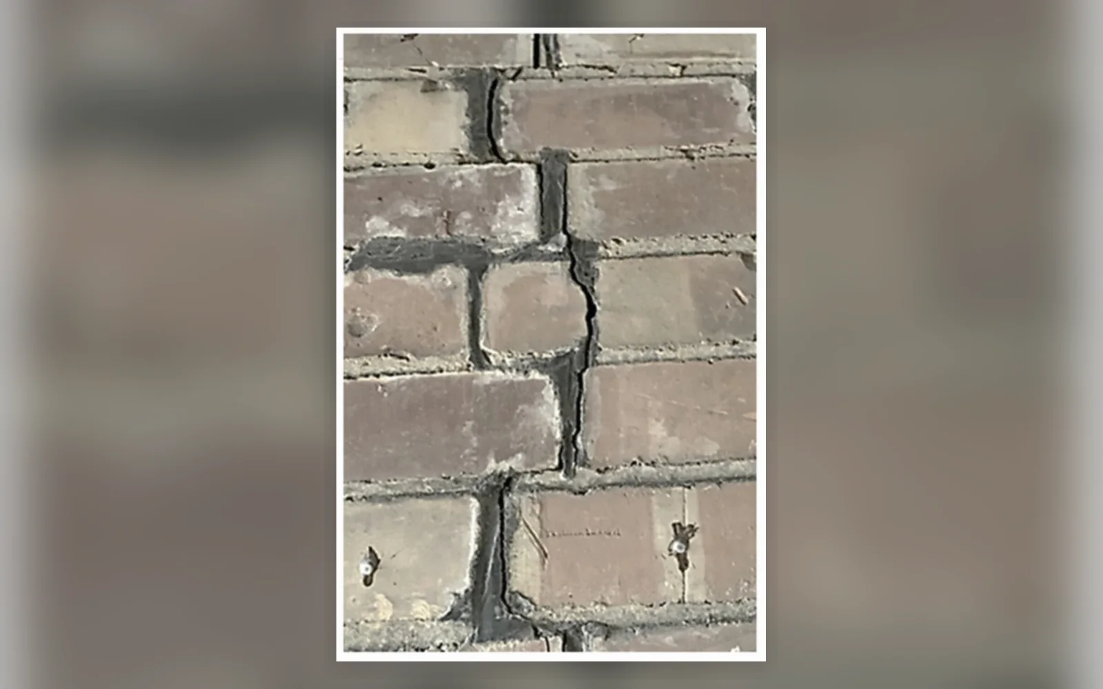 Close-up of stepped cracking through external brickwork