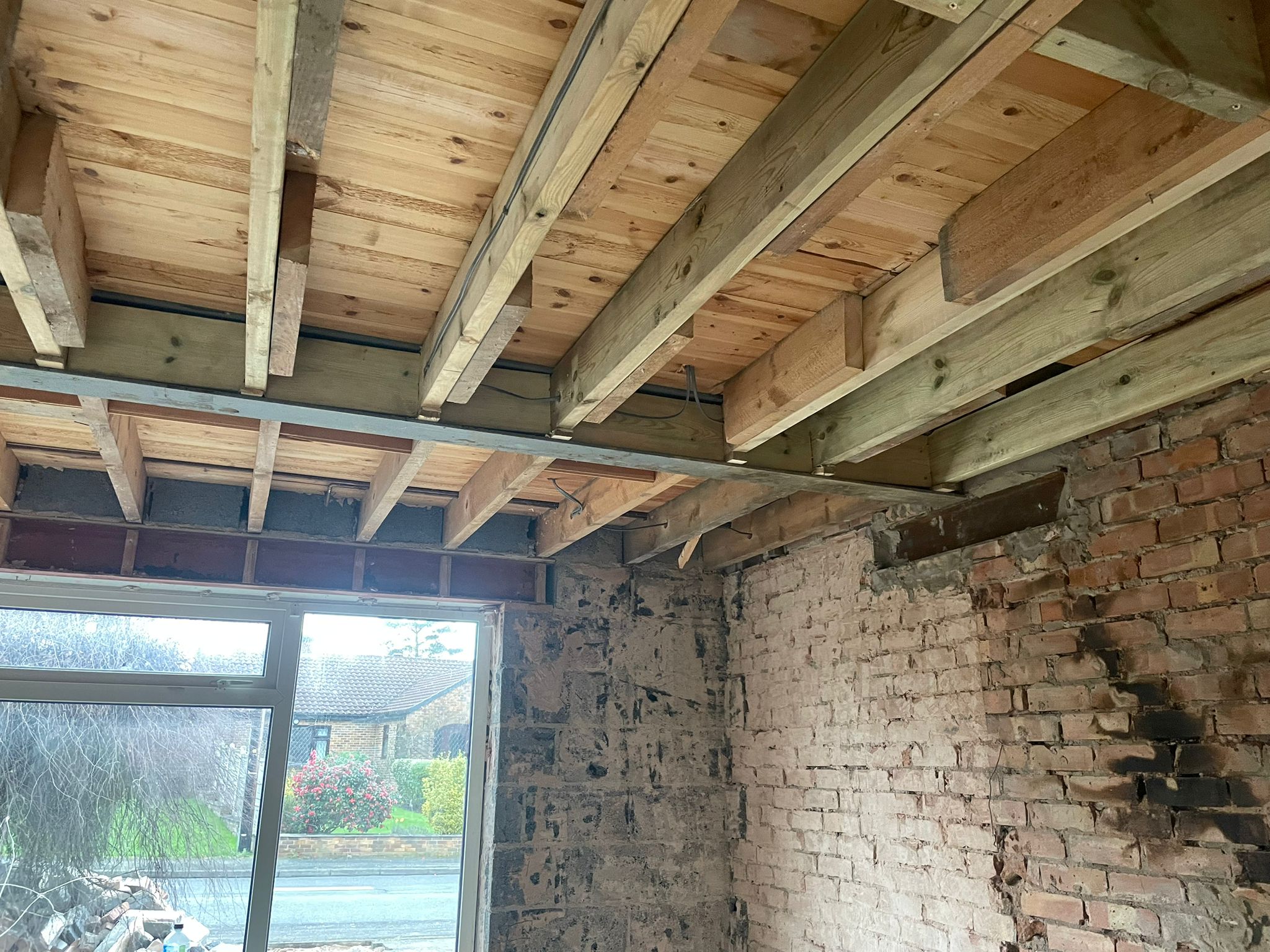Steel beams supporting new floor joists